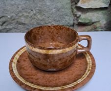 Brown and beige teacup and saucer