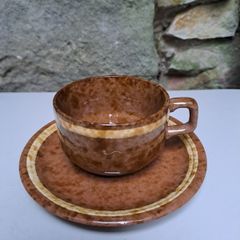 Brown and beige teacup and saucer
