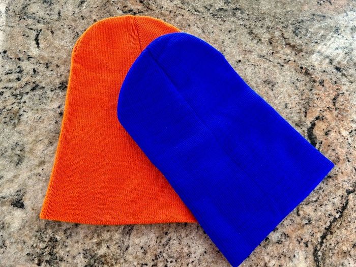 Pair of orange and blue hats