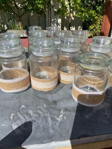 Hessian and lace decorated jars for wedding or party decoration