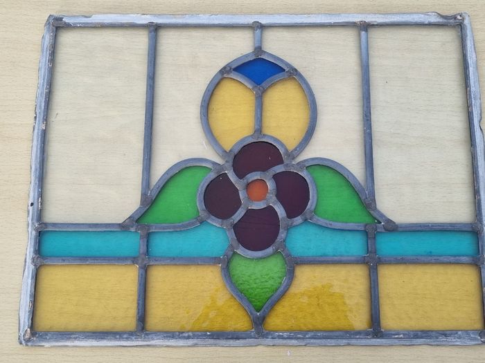 Antique leaded stained-glass panel in the Art Nouveau style.