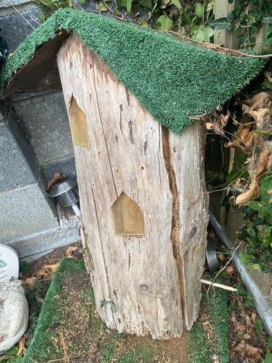 Fairy house perfect for little girl, made from tree trunk & carved out windows & swing, just needs some maintenance