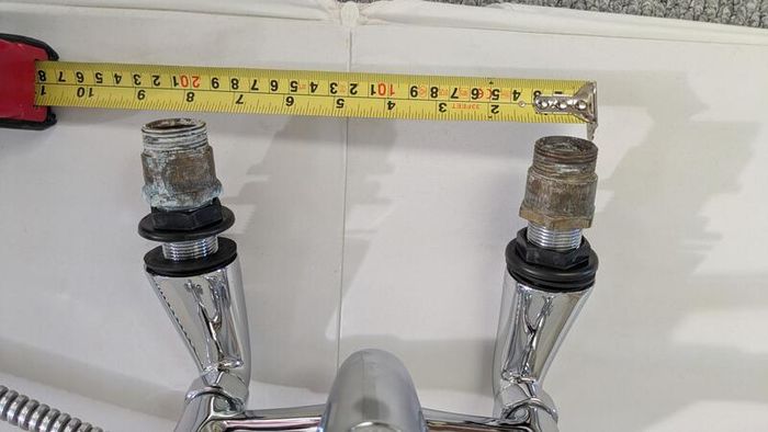 Retro bath mixer with handheld shower head.