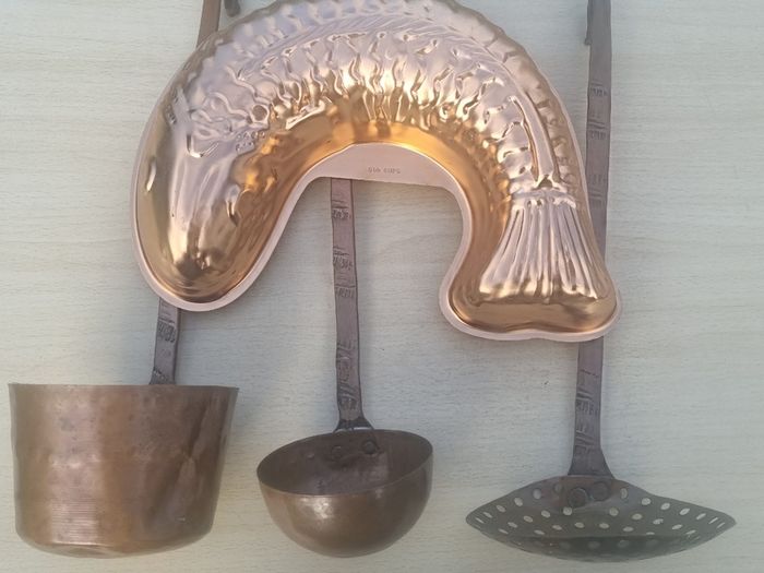 Vintage-style copper cookware and kitchen accessories.