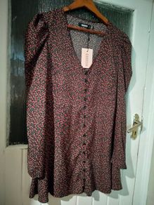 Missguided dress features a ditsy floral print on a black background with button detailing. New with Tags.