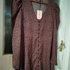 Missguided dress features a ditsy floral print on a black background with button detailing. New with Tags.