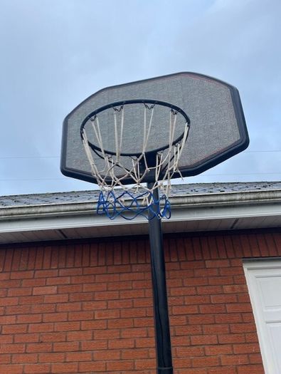 Portable Basketball Stand- Adjustable. stored in garage when not in use. In Very Good Condition.