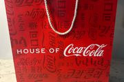 House of Coca-Cola Paper Gift Bag featuring white rope handles
