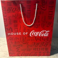 House of Coca-Cola Paper Gift Bag featuring white rope handles