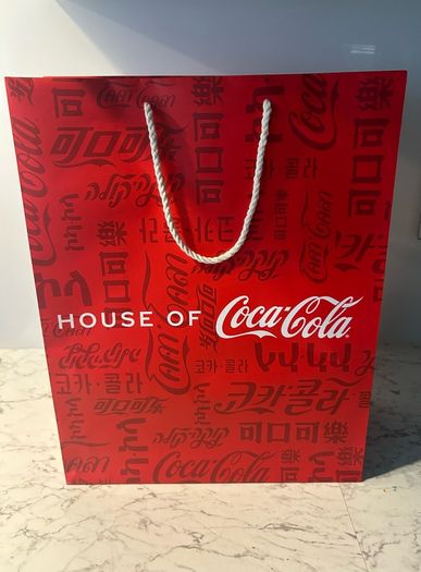 House of Coca-Cola Paper Gift Bag featuring white rope handles