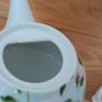 Tea for one: tea pot and cup with rose design on white Image 2