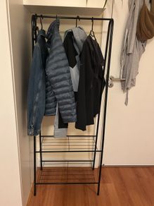 Black rack for clothes and shoes