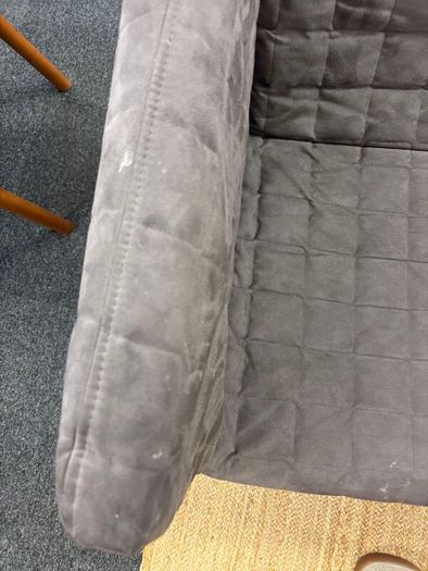 Grey quilted sofa with white metal frame