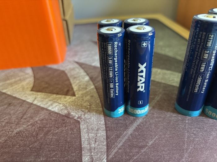 Four 18650 and 21700 Xtar button top batteries