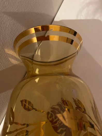 Vintage glass vase with gold decorations.