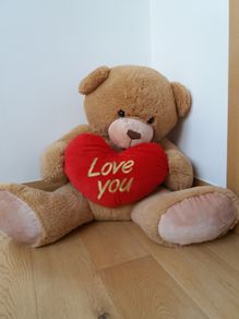 Large Teddy holding a heart