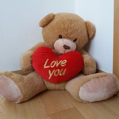 Large Teddy holding a heart
