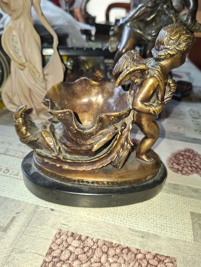 Antique French 19th century Bronze Sculpture Auguste Moreau featuring a Winged Putto Cherub Cupid carrying a shell or cornucopia like vessel, mounted on a marble base