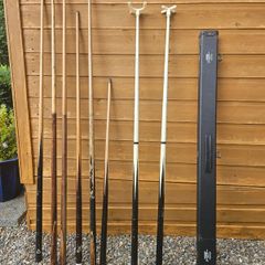 Pool cues, bridge, rest and case.