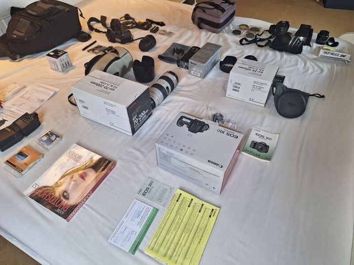 canon camera and pro lenses and a Pentax film system