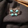 silver tone butterfly cuff bracelet featuring faux turquoise stones and intricate wire work. Image 5