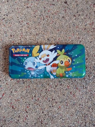 Pokemon tin and cards