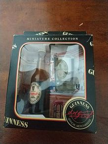 Guinness miniature bottle and glass.