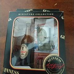 Guinness miniature bottle and glass.