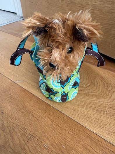 Dog stuffed animal in bag