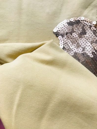 cute yellow t-shirt.  The "apple" has golden sequins