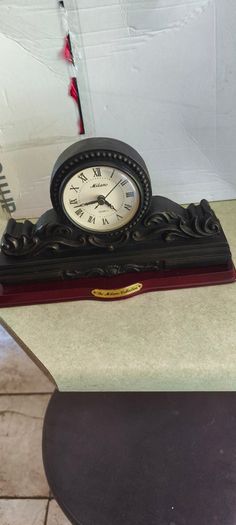 Vintage Bronze-toned Table Clock - Quartz Movement with Wooden Base by The Milano Collection in working order.