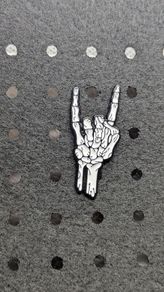 Skelton hand enamel pin