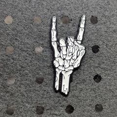 Skelton hand enamel pin