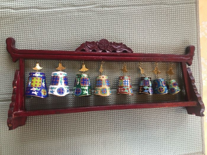 Enamel cloisonne graduated bells on wooden stand