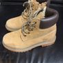 pair of tan/wheat leather boots with a padded dark brown collar. Image 2