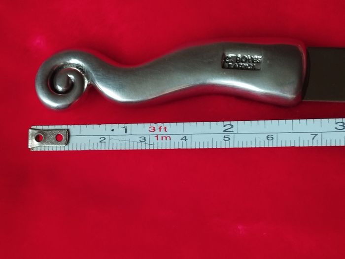 A collectible knife made of polished pewter with a stainless steel blade from Carrol Boyes.