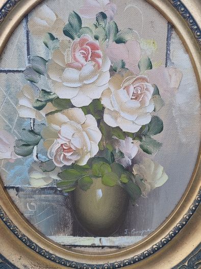 Oval oil painting depicting a still life with flowers,
