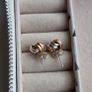 Beautiful silver and rose gold-tone knot stud earrings. Image 3