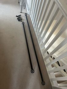 Two grey curtains with curtain poles