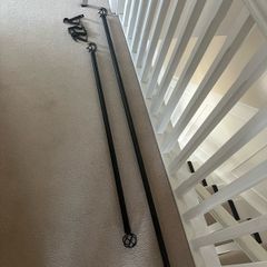 Two grey curtains with curtain poles