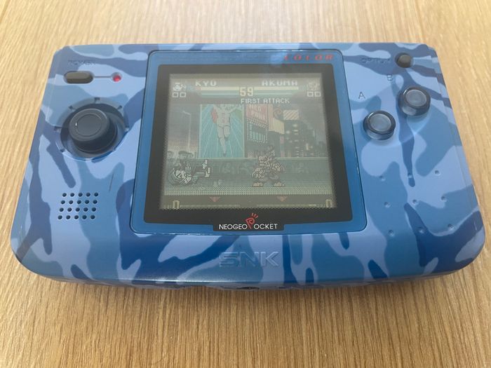 Neo Geo Pocket Color with game SNK vs. Capcom: Match of the Millennium
