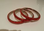 Three Chica red bangles