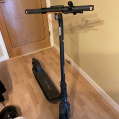 Ninebot E2 scooter with a helmet