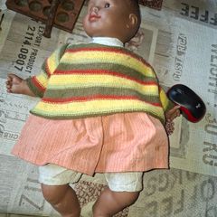 Vintage Beautiful Black Doll, late 20th century, wearing a striped knitted sweater and a peach-colored skirt, Measurements are in the photo's