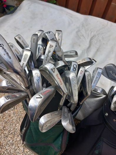 A selection of Golf clubs. Bags and golf balls.