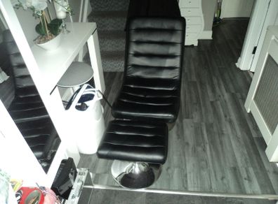 Black leather swivel chair with foot stool