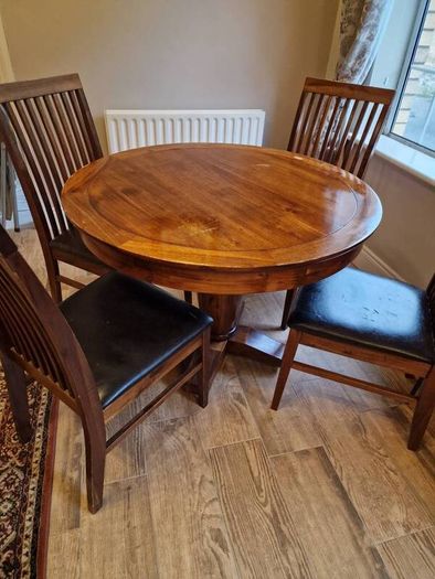Round wooden table and four chairs
