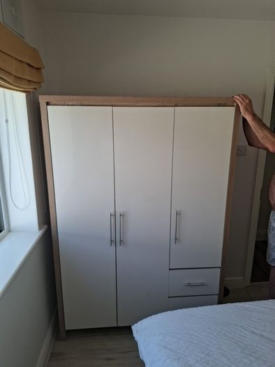 Timer and white wardrobe and bedside locker