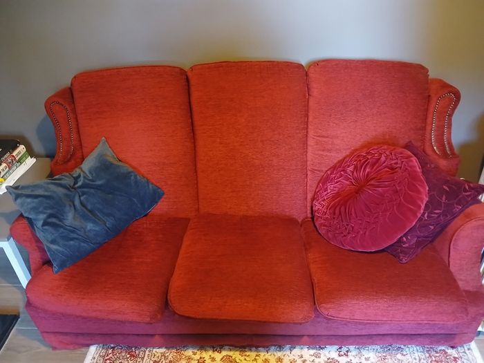 Wooden bed headboard and floral armchair