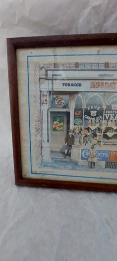 Old advertising shop front picture print ,different brands for sale, in the shop,nice for any home bar or man cave pub restaurant etc,,buyer collects thank you,, rather buyer collects with the glass ,sold as is ,,see pictures for condition